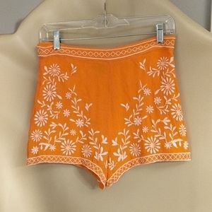 Topshop orange shorts with white embroidery.